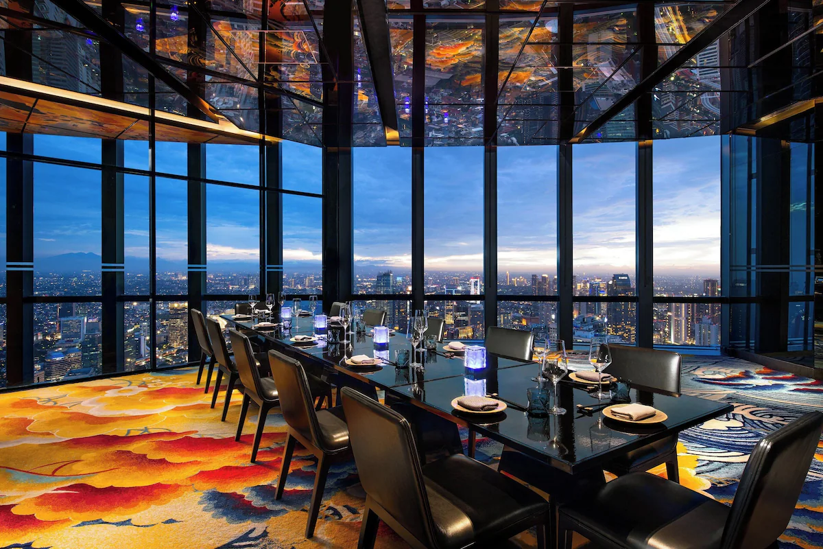 High-rise dining room, city view, vibrant carpet design