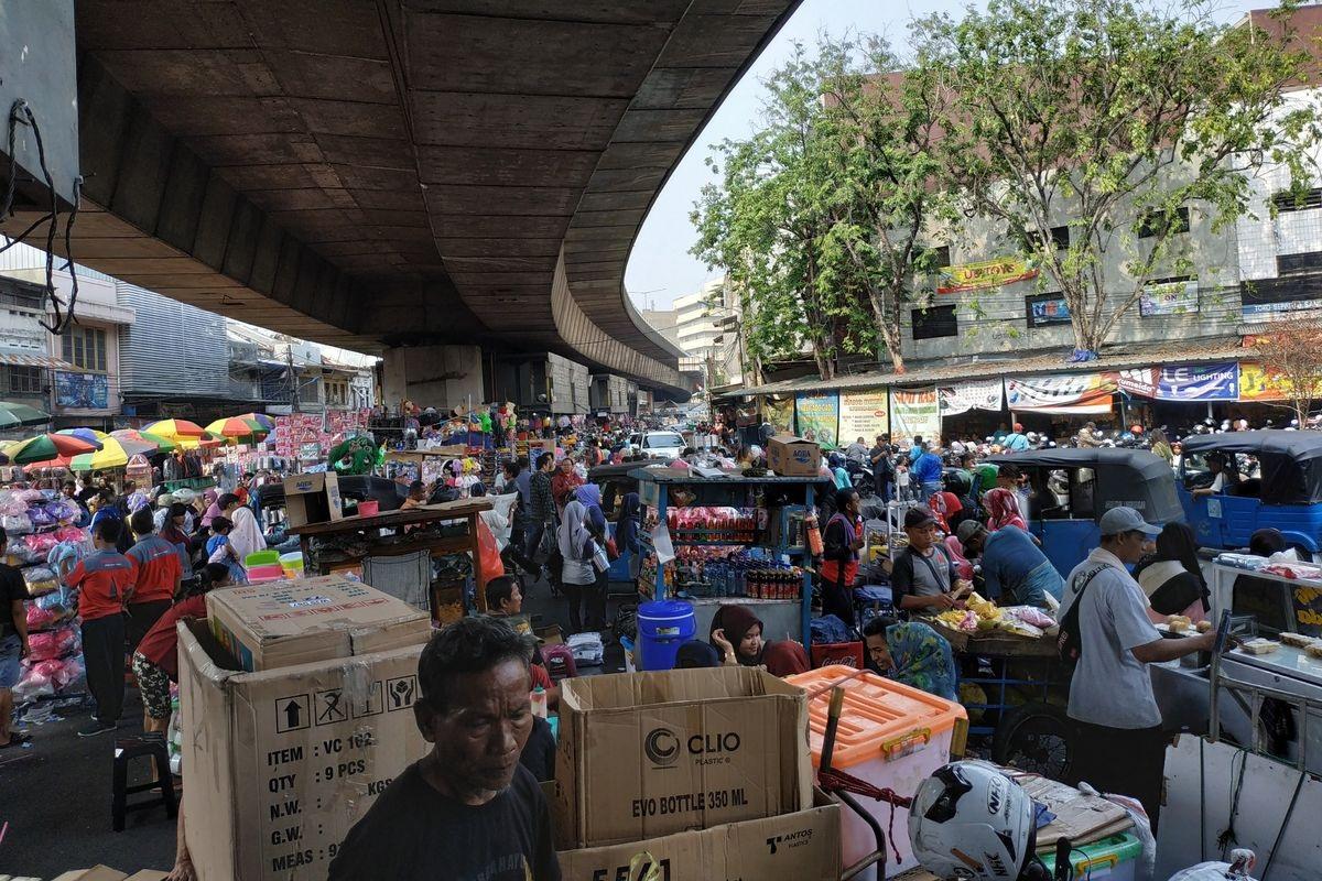 Busy outdoor market under elevated highway