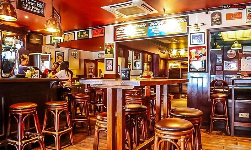 cozy wooden pub interior with bar stools and tables