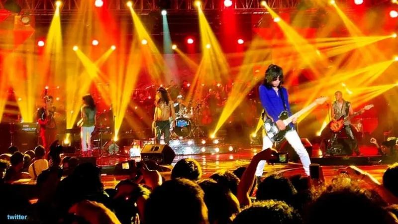 Live rock band on stage with yellow and red lights