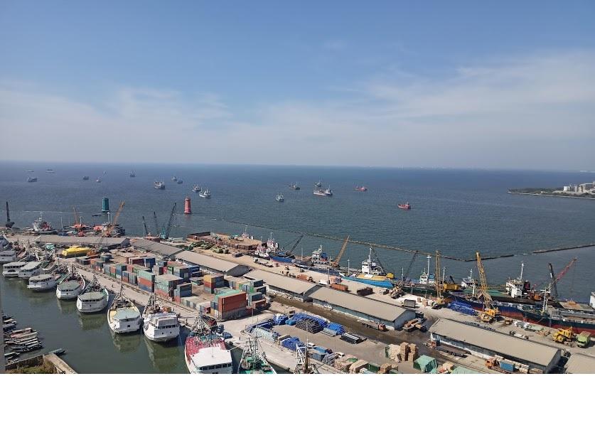 busy shipping port with cranes, container yard and boats