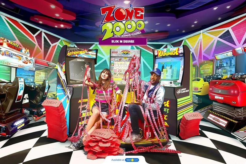 Zone 2000 logo with two people in arcade and tickets