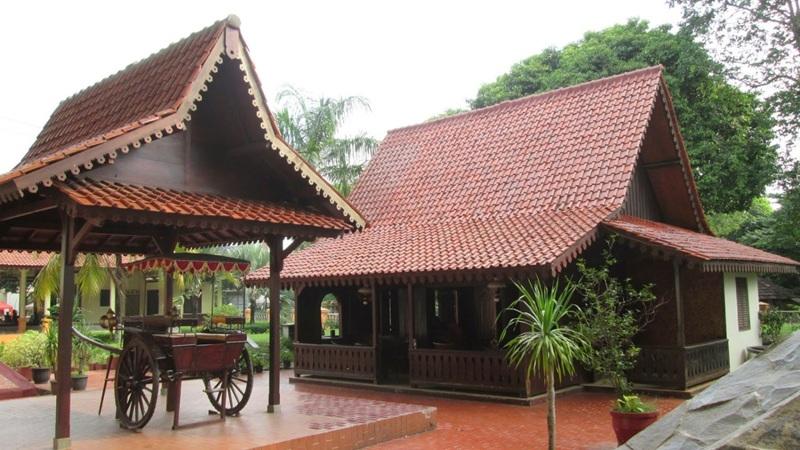 Traditional Malay wooden house with red tiled roofs