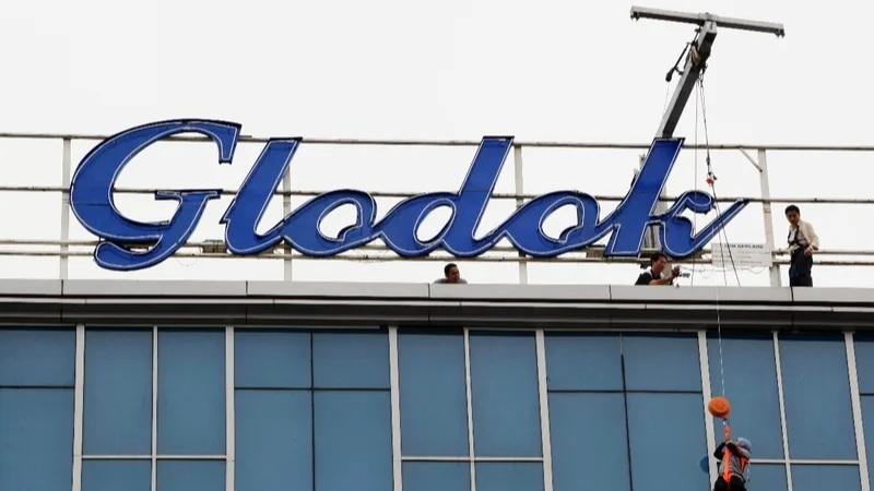 Glodok logo on top of building with workers