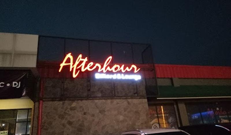 Afterhour neon sign logo on building