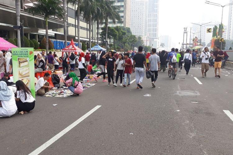 Busy street market and pedestrians on closed city road