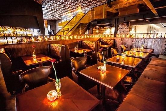 Cozy candlelit restaurant interior with booths