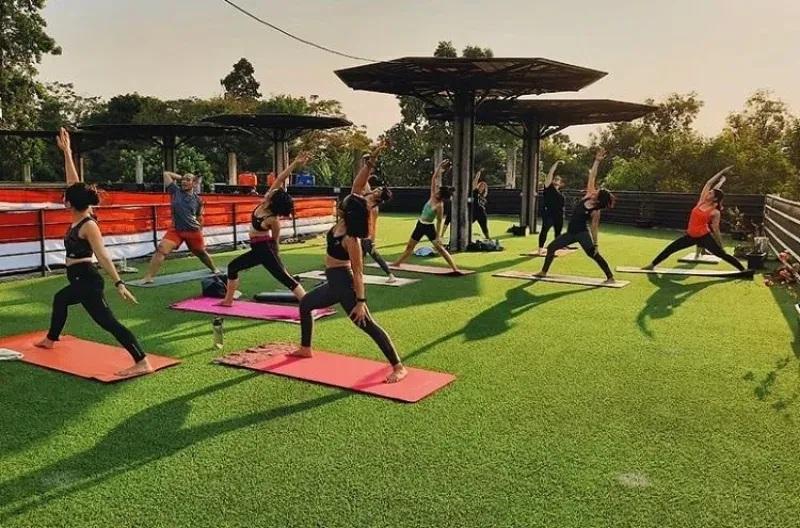 Rooftop yoga class on green turf