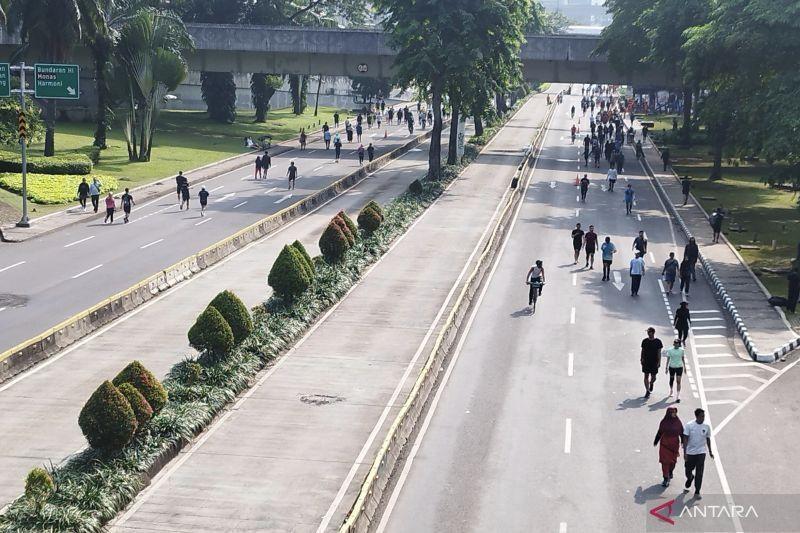 people walking on closed city road during car-free day