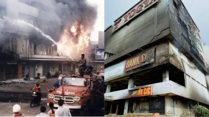 Burning bank building with firefighters and firetruck