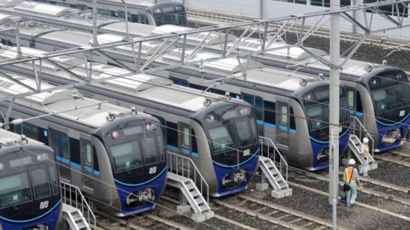 Row of modern blue and silver commuter trains in depot