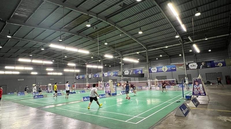 Indoor badminton courts with players practicing