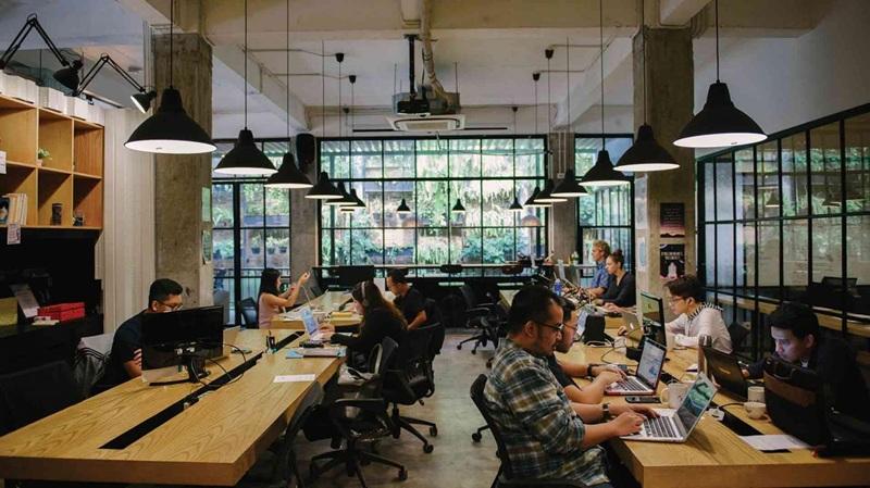 Open-plan coworking space with people on laptops
