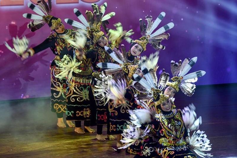 Group of dancers in traditional feathered costumes