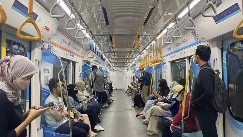 Masked passengers seated and standing in subway car