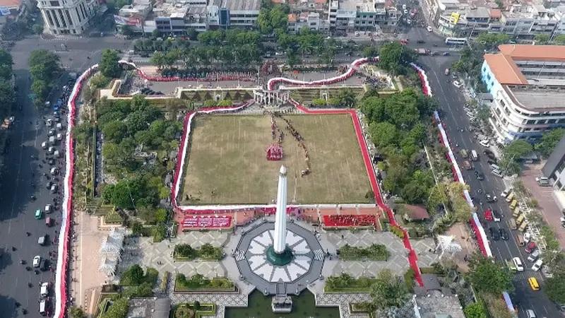 Aerial view of city park with central obelisk monument