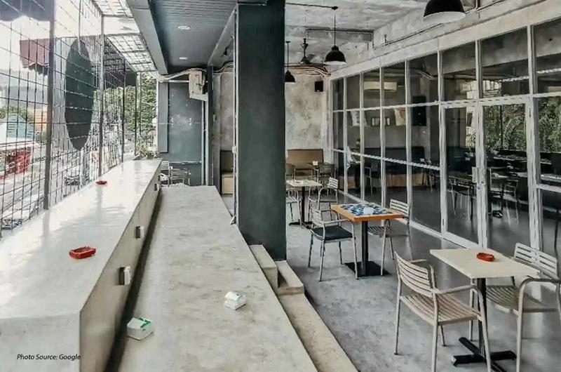Industrial cafe interior with concrete counter and tables