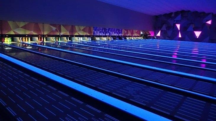Neon bowling alley lanes under blacklight