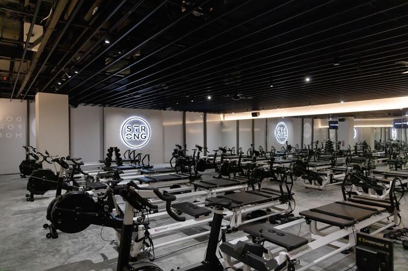 Pilates reformer studio with STRONG neon logo