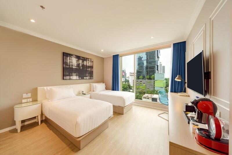 Hotel room with two beds and city view