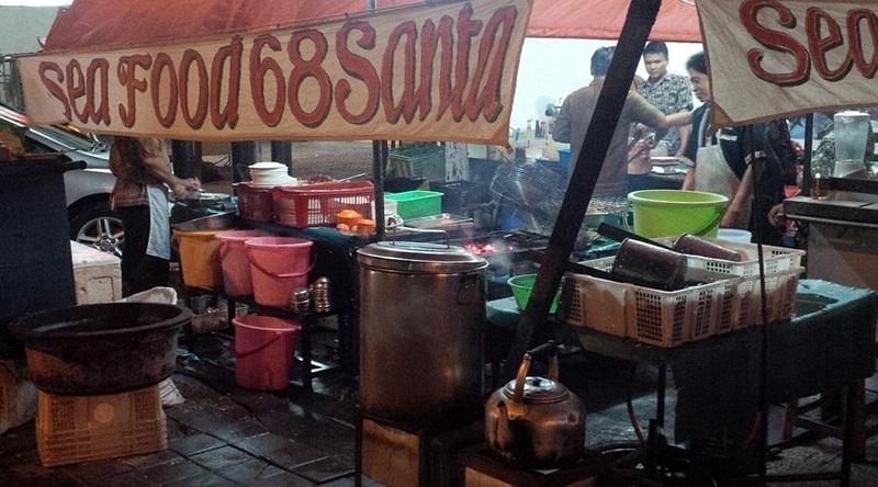 Street seafood stall with banner Sea Food 68 Santa