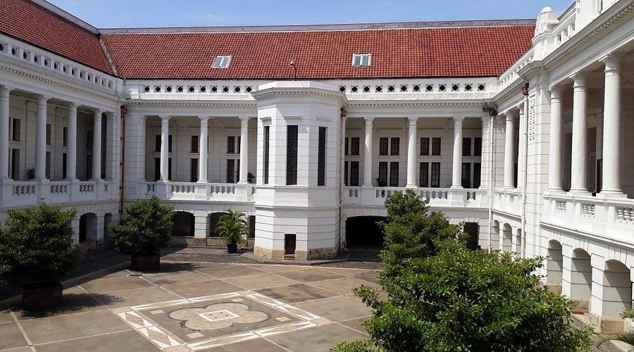 White neoclassical building courtyard with red roof