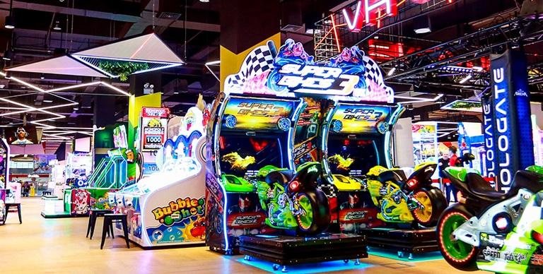 Arcade with neon motorcycle racing game machines