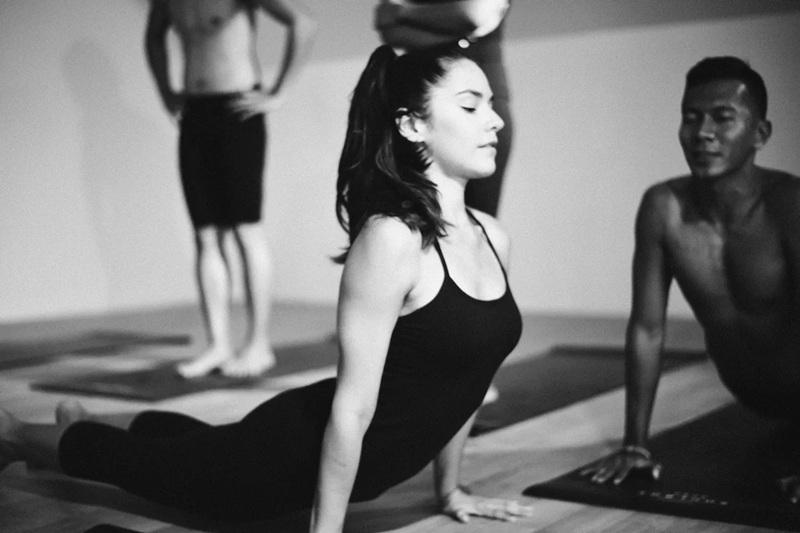 Woman in yoga class doing cobra pose