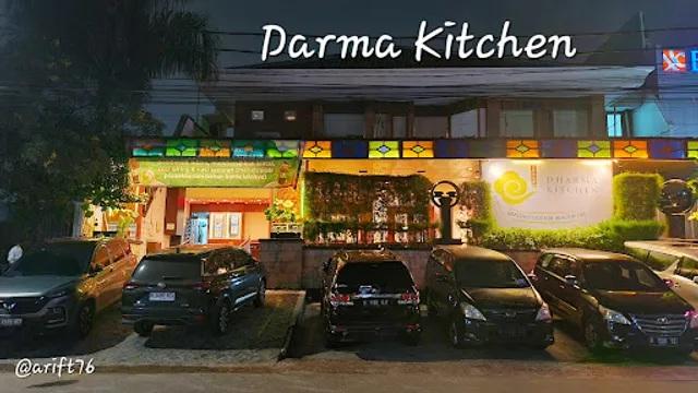 Darma Kitchen logo on restaurant facade at night