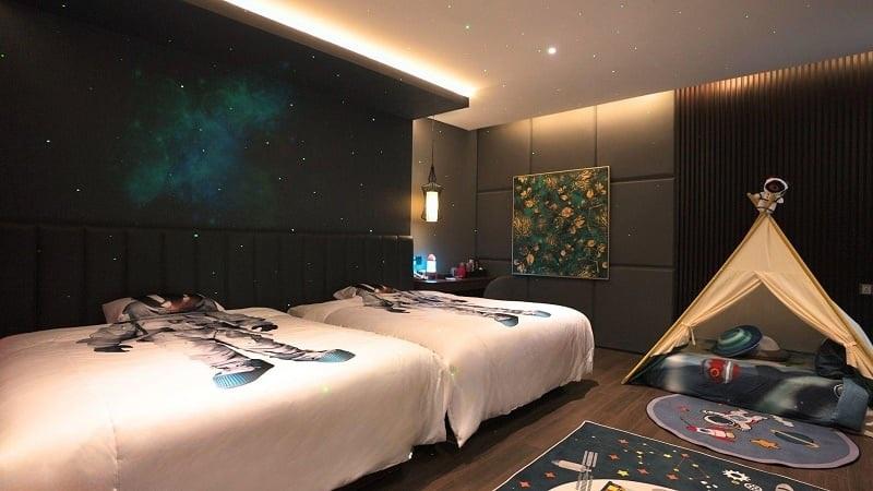 Space-themed kids bedroom with twin astronaut beds