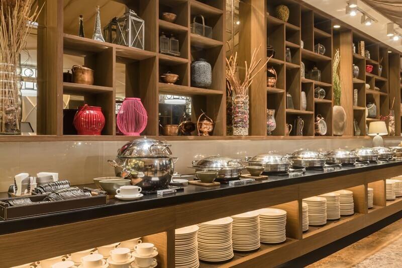 hotel buffet line with chafing dishes and plates