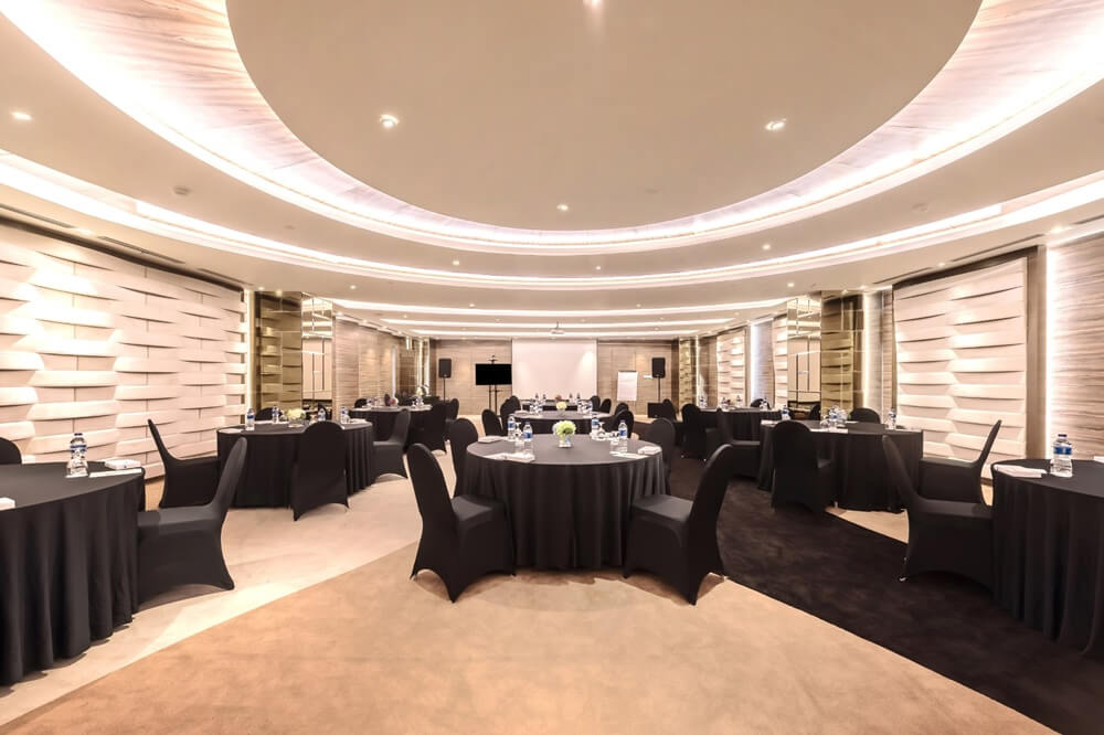 Conference room with round tables and black chairs