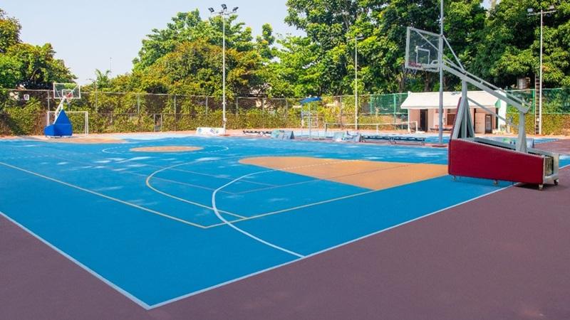 Outdoor blue basketball court with two portable hoops