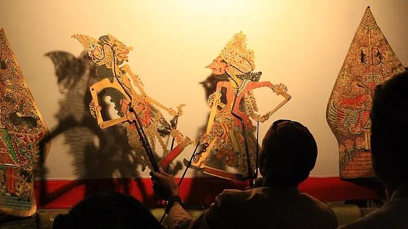Wayang kulit shadow puppet performance with puppeteers