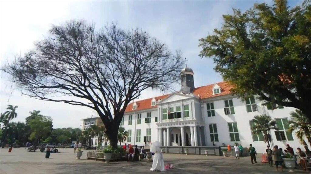 Historic white museum facade with large leafless tree