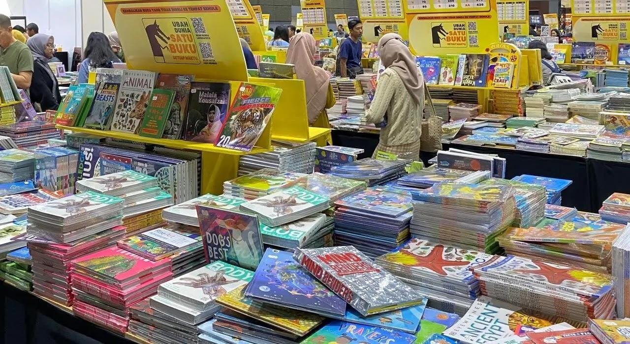 Busy book fair tables stacked with colorful children's books