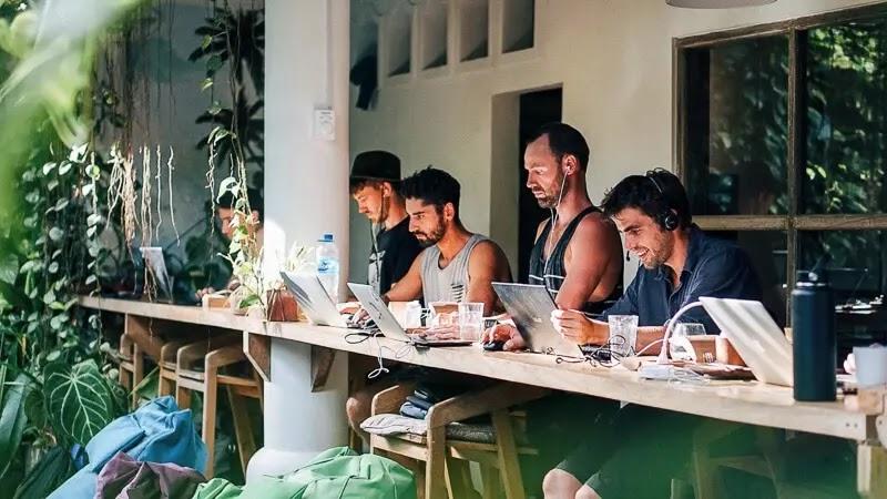 Group of people working on laptops at outdoor coworking