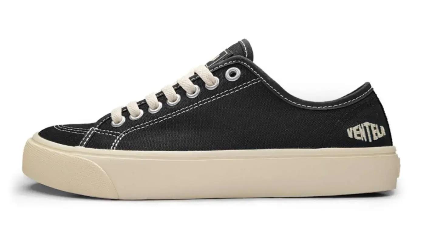 black canvas low-top sneaker with cream sole