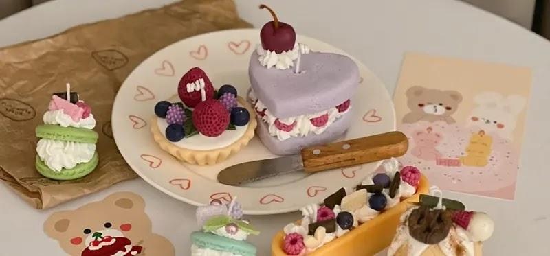 Assorted pastel mini desserts on plate with knife