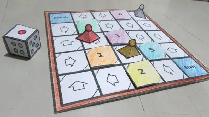 handmade paper board game with dice and pawns