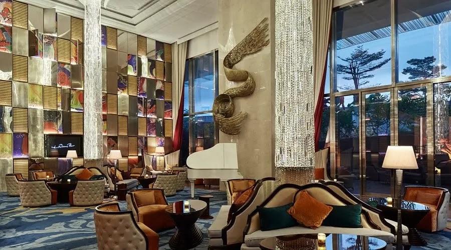 luxury hotel lobby with grand piano and chandeliers