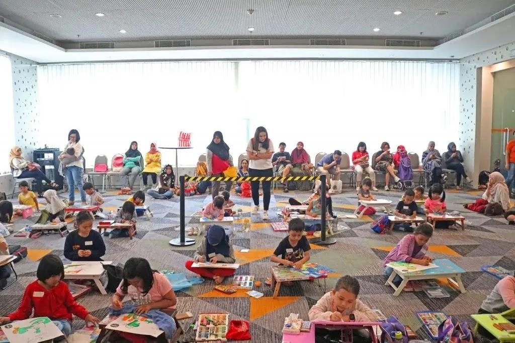 Children painting in group art class