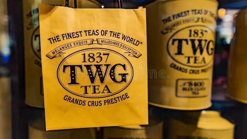Yellow TWG Tea logo on paper shopping bag