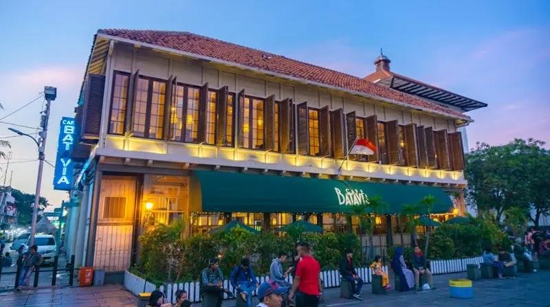 Cafe Batavia colonial building at dusk with people