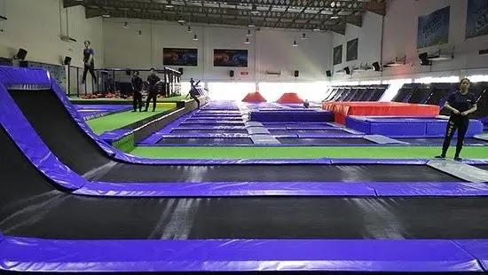 Indoor trampoline park with purple and black mats