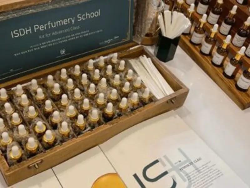 ISDH Perfumery School logo on display with perfume vials