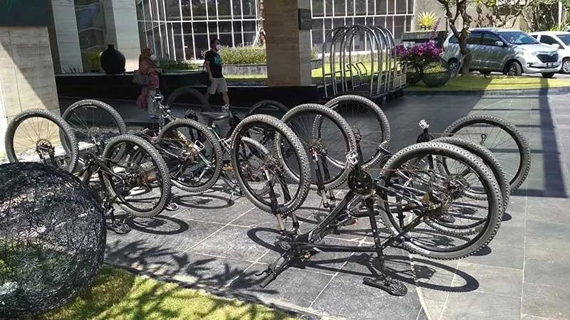 Multiple bikes flipped upside down on outdoor plaza