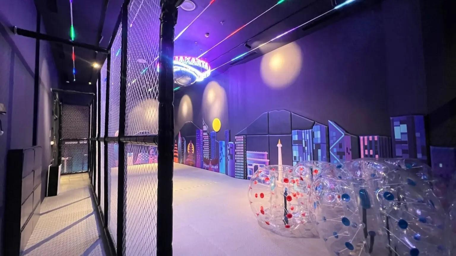 Indoor neon city mural with bubble soccer balls