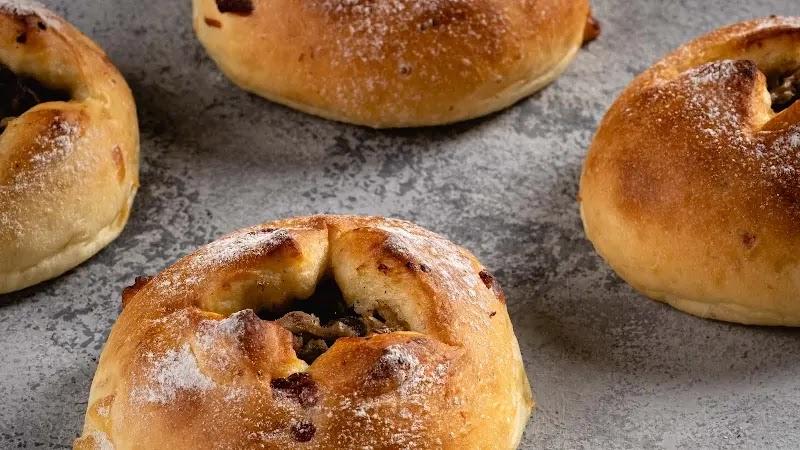 Fresh baked stuffed bread rolls dusted with flour