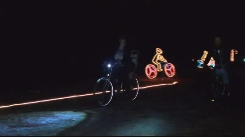Night scene of cyclists with neon light bicycle decorations